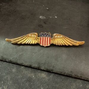 This is a World War II era U.S. Army Air Forces "sweetheart wings" brooch,
